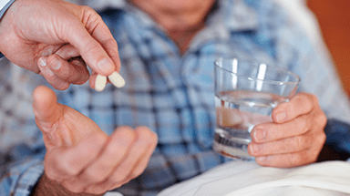 Healthcare professional giving a patient medication to take